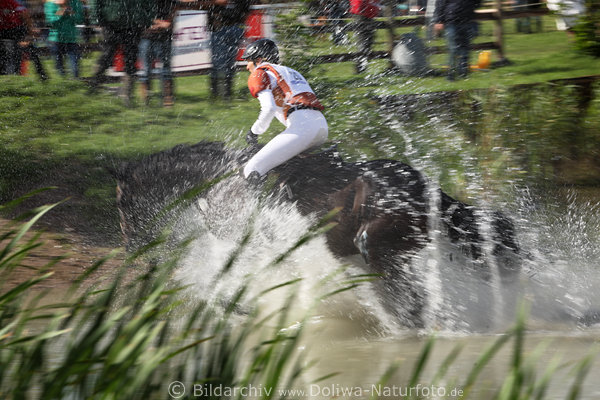 Horserider cross over water squirts blur fuzziness action watercross open-country