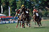 Pologame action-image poloplayer to running horses behind the ball on playing field, polo-tournament ball-contact