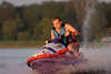 45620_Jetski driving in water-squirts picture teenagermotor dynamic-trip speed at water, watersport fun rider
