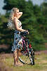 Girl pretty bike-women portrait on the way with bicycle in nature heath-landscape