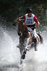Horserider in watersquirts equestrian watercross photo action art image horse open-country riding movement dynamic