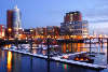 Hamburg harbor photo in winter twilight mood on elbe river port lights waterscape picture with city buildings hanseatic trade center